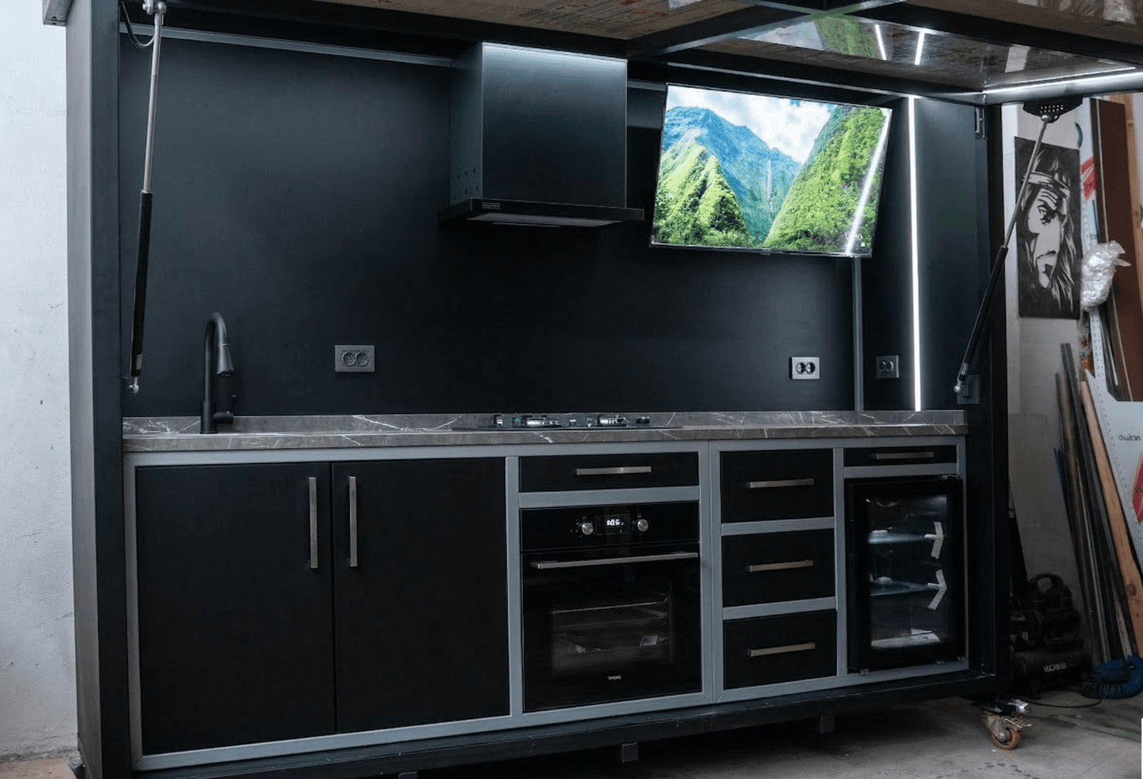 Siyah modern arka planlı ve entegre televizyonlu lüks dış mekan mutfak tasarımı.